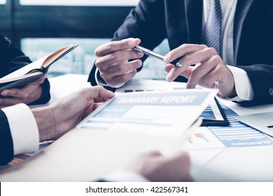 Group Of Business People Busy Discussing Financial Matter During Meeting