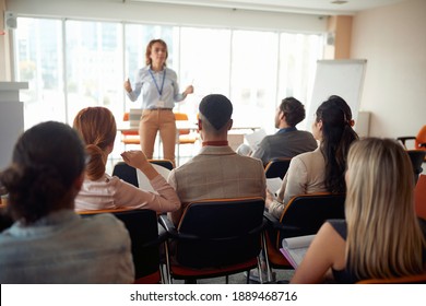 Group of business people carefully listening to a lecturer in a working atmosphere at seminar. People, company, job, business concept.