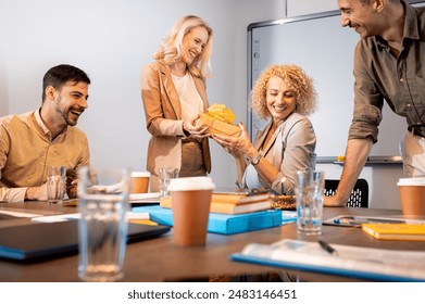 Group of business people celebrating birthday of their colleague at office. - Powered by Shutterstock