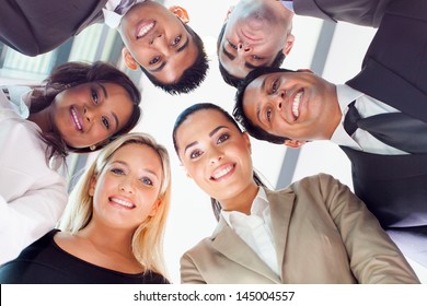 Group Of Business People In A Circle Looking Down