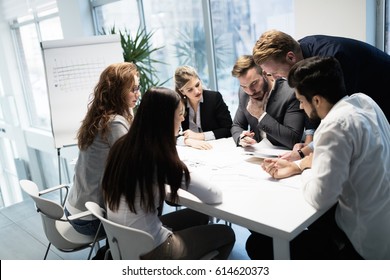 Group Of Business People Collaborating On Project  In Office