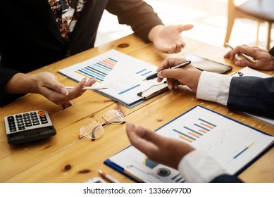 Group of business people discussing with analyzing data financial report at the office desk on montly meeting. Accounting concept. - Shutterstock ID 1336699700