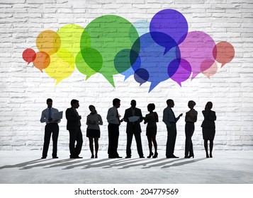 Group of business people discussing with colorful speech bubbles above them. - Powered by Shutterstock