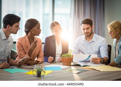 Group of business people discussing at desk in the office