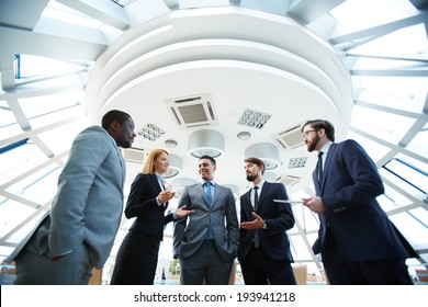 Group Of Business People Discussing Ideas At Meeting