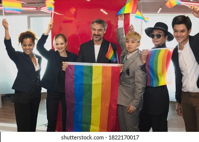 Group Of Business People With Diverse Genders (LGBT) Celebrate LGBT Freedom And Support With LGBT Flag In The Meeting Room At Office Workplace