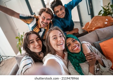 Group Of Business People During Break From The Work Taking Selfie Picture While Enjoying Free Time In Relaxation Area At Modern Open Plan Startup Office. Selective Focus 