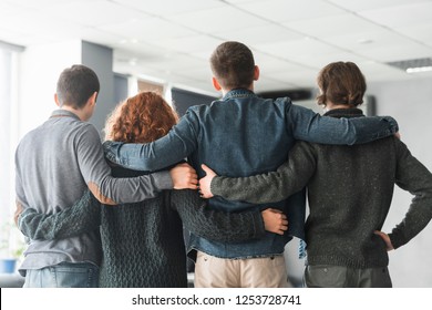 Group Of Business People Embracing From Behind