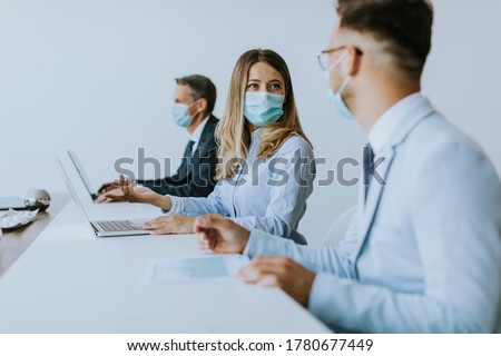 Group of business people have a meeting and working in the office and wear protective facial masks as protection from corona virus