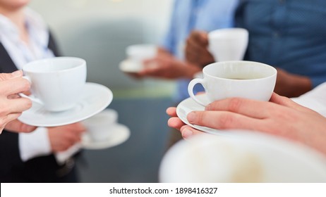 Group Of Business People Having Coffee Together During A Break In The Office