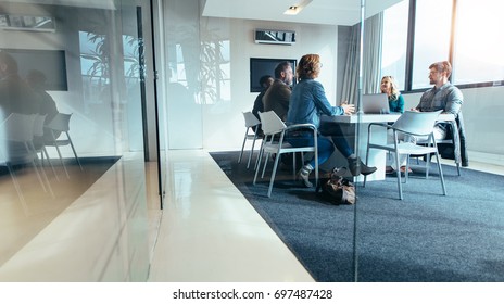 Group of business people having discussion in conference room. Creative business team brainstorming over new project. - Shutterstock ID 697487428