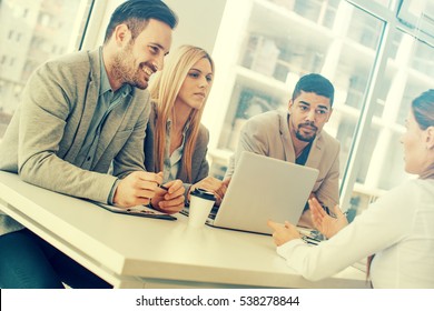 Group of business people having job interview.They are communicating with female candidate.