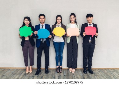 Group Of Business People Holding A Speech Bubble Icon