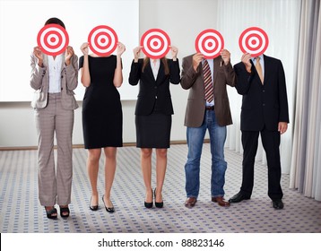 Group Of Business People Holding A Target Against Their Faces