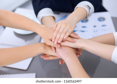 Group of business people joining hands, close-up. Teamwork, cooperation and success concept of communication - Shutterstock ID 1160162497