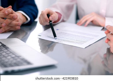 Group Of Business People And Lawyers Discussing Contract Papers Sitting At The Table, Close Up