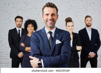 Group of business people with leader at front - Shutterstock ID 443139169
