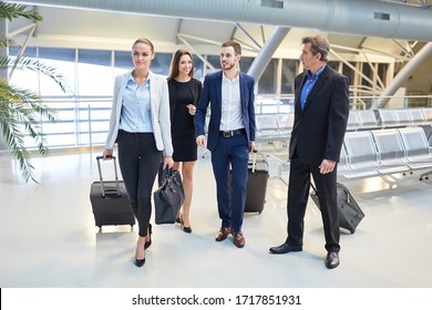 Group Of Business People And Managers As A Team Arriving At The Airport Terminal