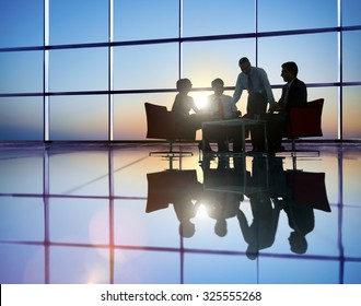 Group Of Business People Meeting In Back Lit Concept