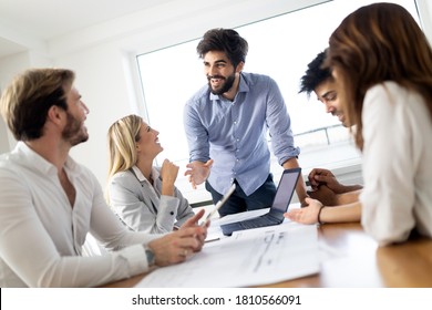 Group Of Business People Meeting In Office, Sharing Their Ideas.