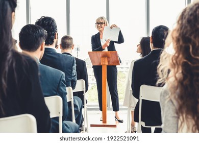 Group Of Business People Meeting In A Seminar Conference . Audience Listening To Instructor In Employee Education Training Session . Office Worker Community Summit Forum With Expert Speaker .