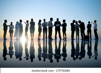 Group Of Business People Meeting With Sunset