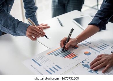 Group business people meeting together Pointing to the graph assess business profits 
