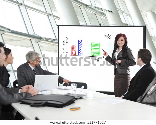Group of business people in office at presentation\
with flip chart