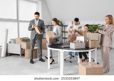 Group of business people packing things in office on moving day - Powered by Shutterstock