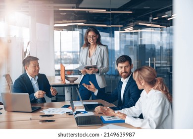 A group of business people partners during a set team meeting in the modern office.High quality  - Shutterstock ID 2149639987