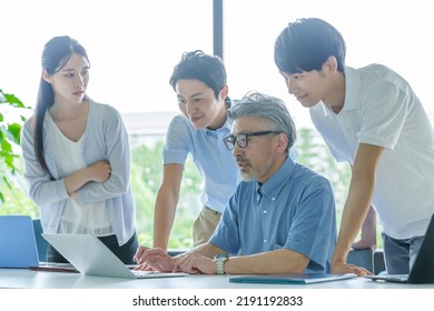 Group Of Business People Paying Attention To The Computer Screen