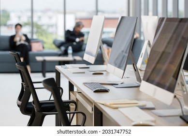 Group Of Business People Relax Time In Modern Office.there Are Many Computers On The Table. 
This Image Is Blurry.