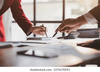 Group business people are reviewing monthly sales documents analysis and marketing plans for more sales growth, they are the founders of young companies co-founding startups. Sales management concept. - Shutterstock ID 2276170951