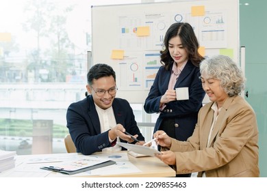 Group Of Business People Sitting Around The Office Desk And Discussing The Project Together.Business Meeting Time.