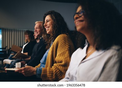 Group of business people sitting at seminar. People sitting in audience smiling during a convention. - Shutterstock ID 1963356478
