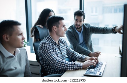 Group Of Business People And Software Developers Working As A Team In Office