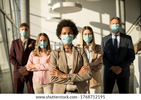 Group of business people standing in the office and wear mask for protect prevent infection by corona virus