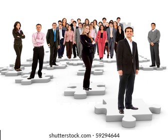 Group Of Business People Standing On The Pieces Of A Puzzle - Isolated Over A White Background