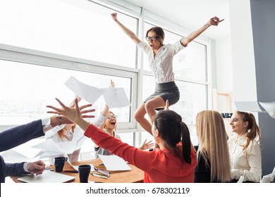 Group of business people supporting dancing female colleague