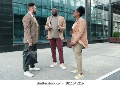 Group Of Business People Talking To Each Other While Standing Near The Office Building In The City