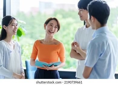 group of business people talking in the office - Shutterstock ID 2190739661