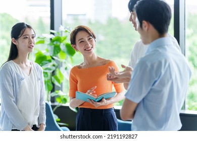 group of business people talking in the office - Shutterstock ID 2191192827