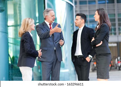 Group Of Business People Talking Outdoor In An Urban Setting 