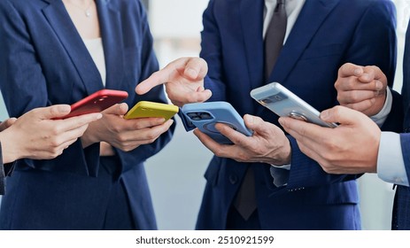 A group of business people using apps and watching videos on their smartphones - Powered by Shutterstock