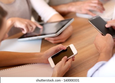 Group Of Business People Using Electronic Devices At Work