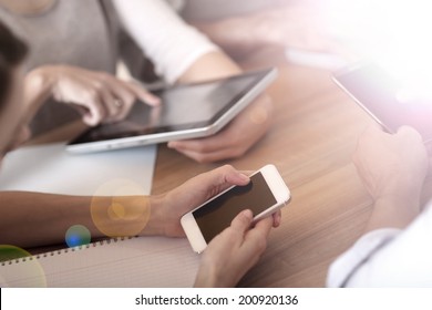 Group Of Business People Using Electronic Devices At Work