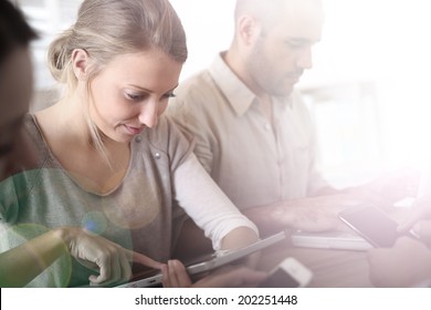 Group Of Business People Using Electronic Devices At Work