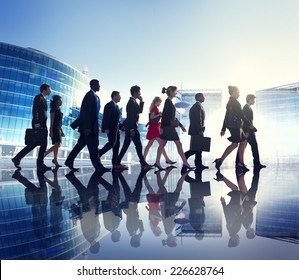 Group Of Business People Walking Back Lit Concept