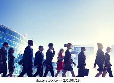 Group Of Business People Walking Back Lit Concept