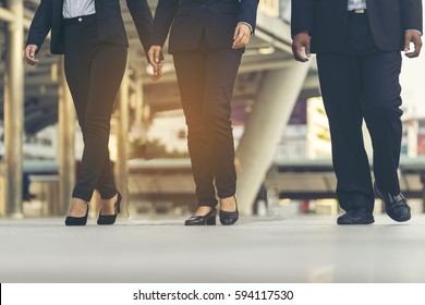 Group Of Business People Walking At Corridor Or Hallway. Businessman's Feet Is Step Up. Business Concept. 